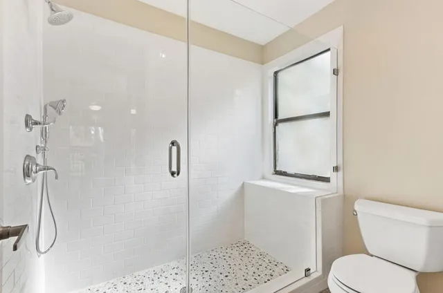 a white toilet sitting next to a bathroom sink