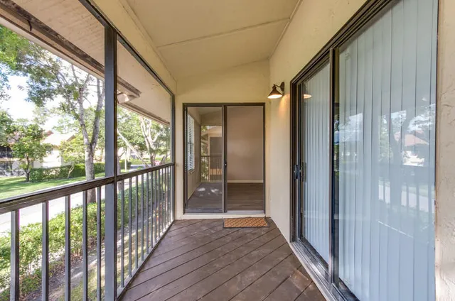 a view of a balcony with wooden floor