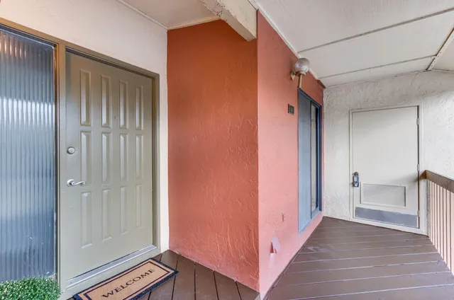 a view of a hallway with closet and bathroom