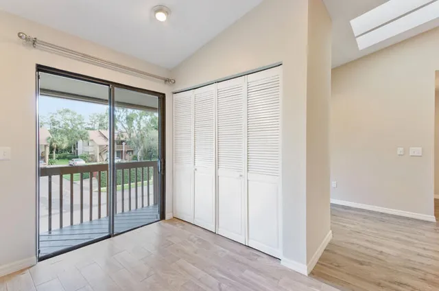a view of a room with wooden floor and windows