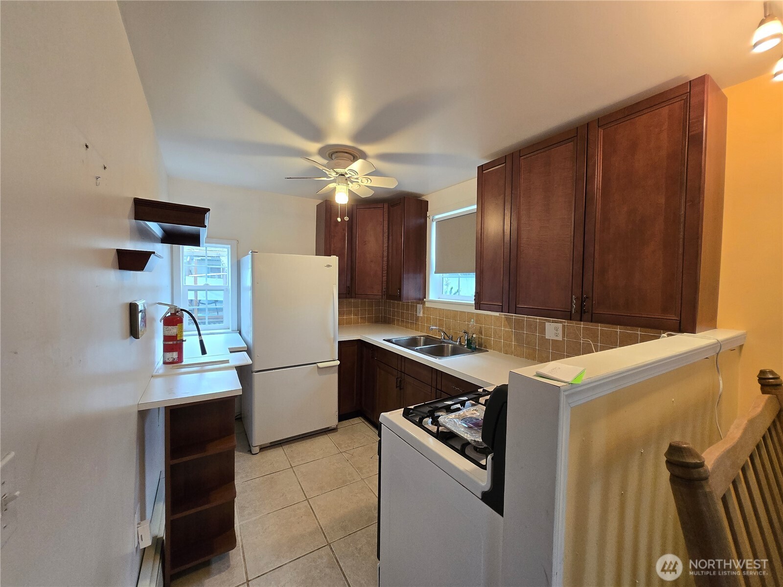 2205 300th Place Ocean Park, WA 98640 - Photo 14 of 20 a kitchen with a refrigerator a stove top oven and cabinets