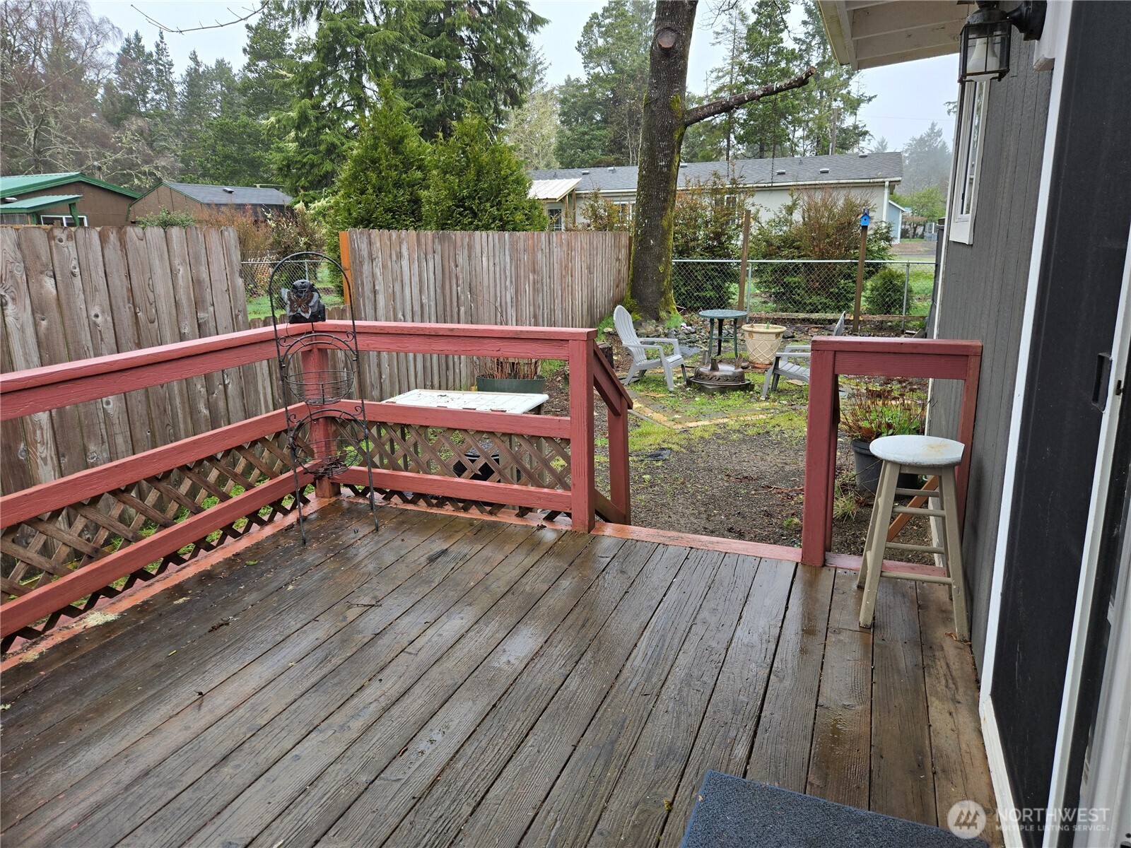 2205 300th Place Ocean Park, WA 98640 - Photo 5 of 20 a balcony with wooden floor outdoor seating and yard in the back