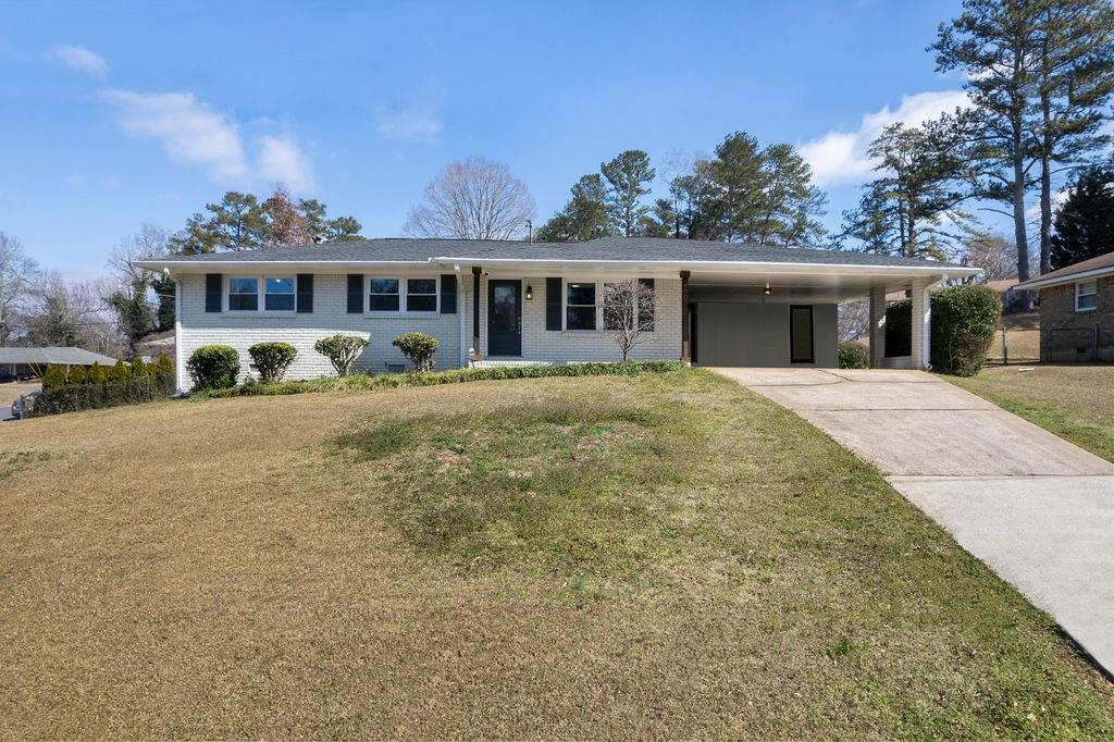 2601 Callaway Road Southwest Marietta, GA 30008 - Photo 1 of 1 a front view of a house with a garden