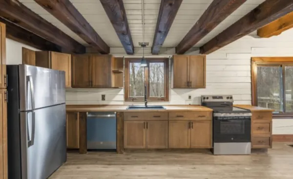 a view of a kitchen with a sink and cabinets