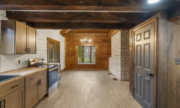 a view of empty room with fireplace and wooden floor