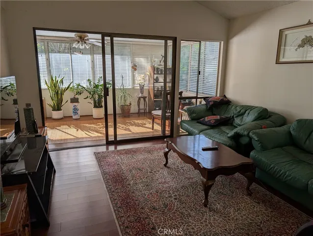 a living room with furniture and a floor to ceiling window