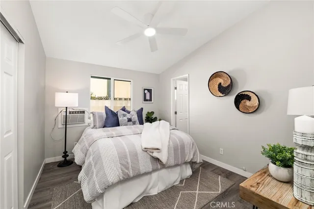 a bed room with a bed and a chair with the potted plant