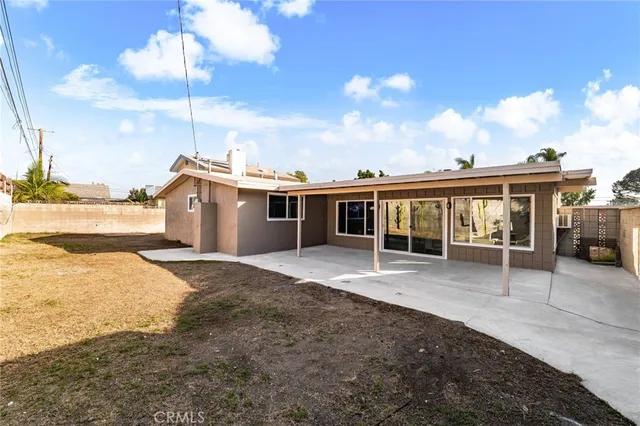 a front view of a house with a yard and seating space