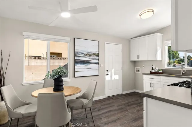a living room with furniture wooden floor and a potted plant