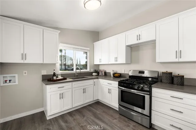 a kitchen with granite countertop white cabinets and white appliances