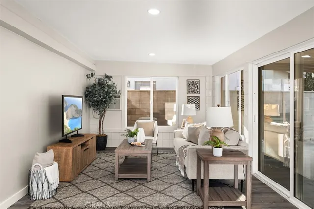 a living room with furniture and a floor to ceiling window