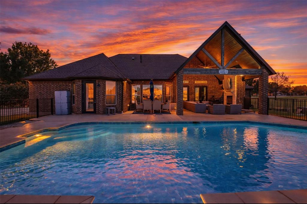 a front view of a house with swimming pool having outdoor seating