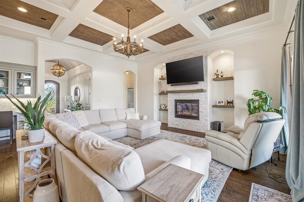 2009 Tree Top Court Granbury, TX 76049 - Photo 11 of 40 a living room with fireplace furniture and a flat screen tv