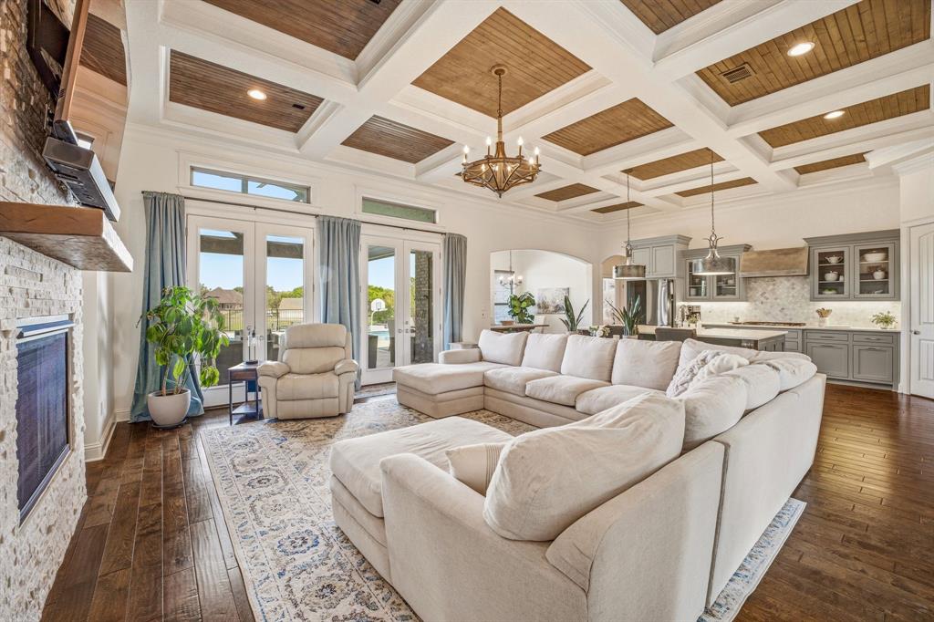 2009 Tree Top Court Granbury, TX 76049 - Photo 12 of 40 a living room with furniture wooden floor and a fireplace