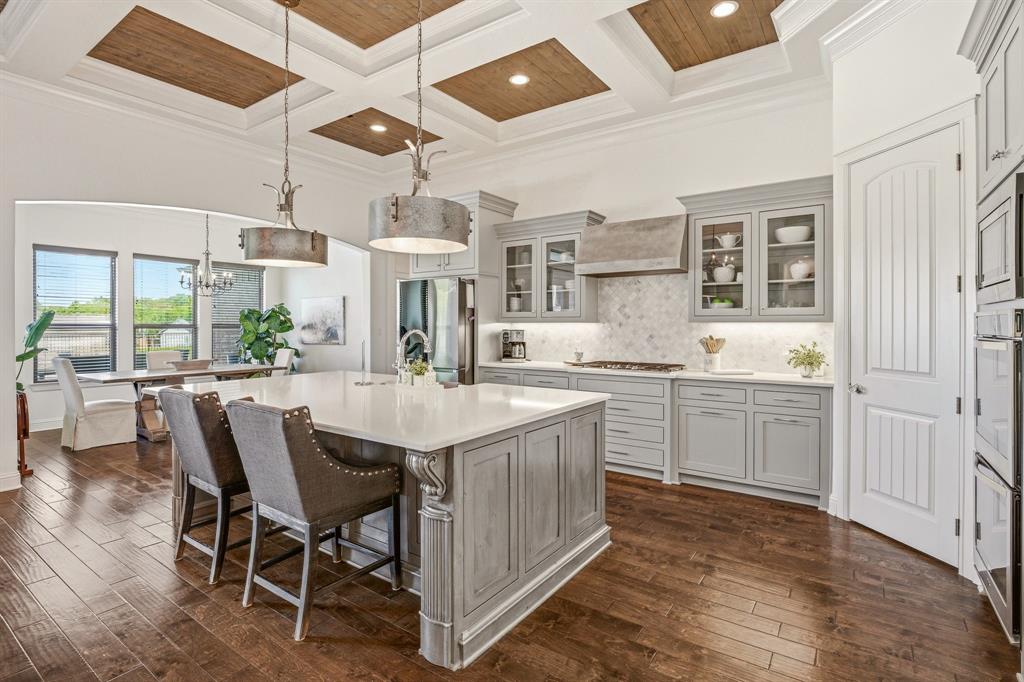 2009 Tree Top Court Granbury, TX 76049 - Photo 13 of 40 a kitchen with a table chairs sink and cabinets