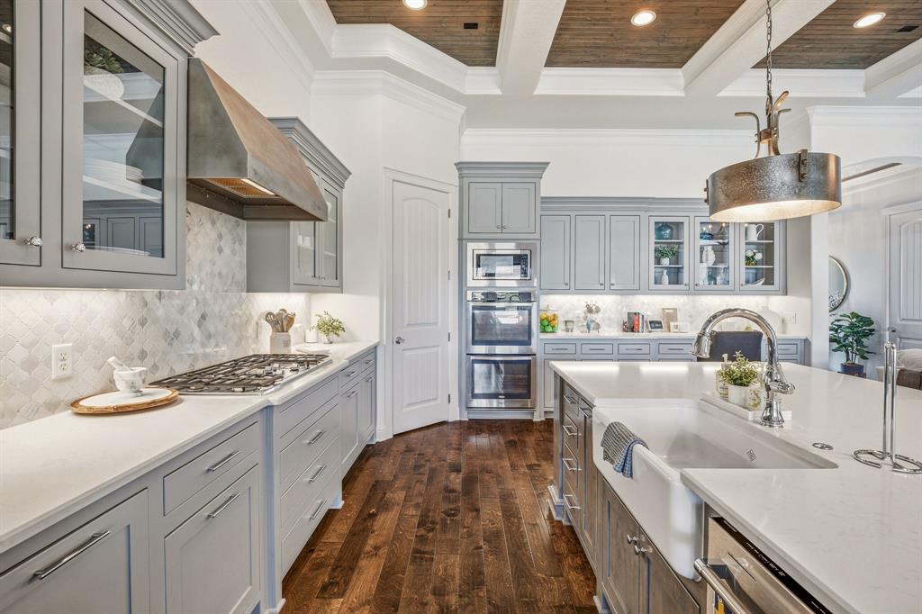 2009 Tree Top Court Granbury, TX 76049 - Photo 15 of 40 a kitchen with a sink stove top oven and cabinets
