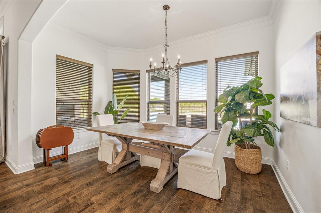 2009 Tree Top Court Granbury, TX 76049 - Photo 19 of 40 a dining room with furniture potted plants and wooden floor