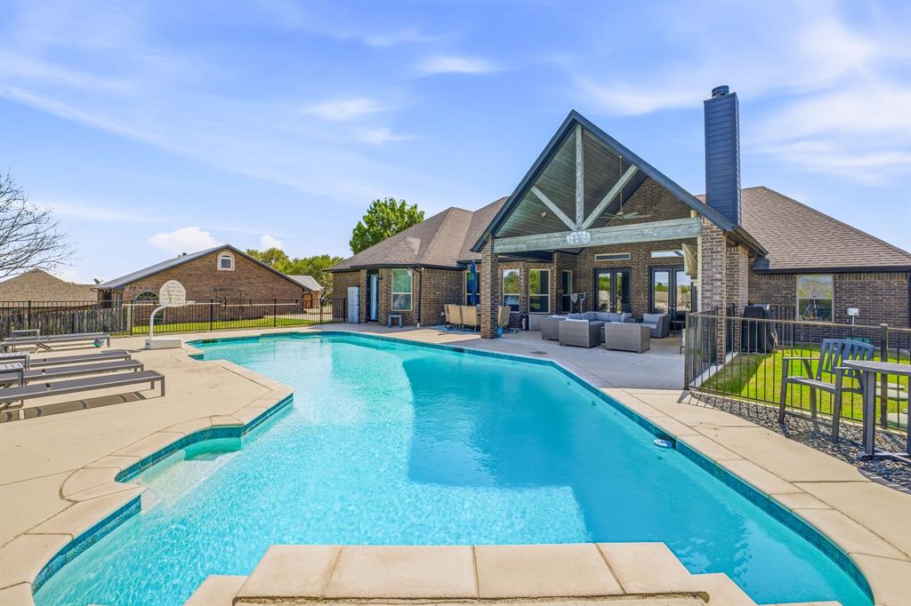 2009 Tree Top Court Granbury, TX 76049 - Photo 2 of 40 a view of house with outdoor space and swimming pool