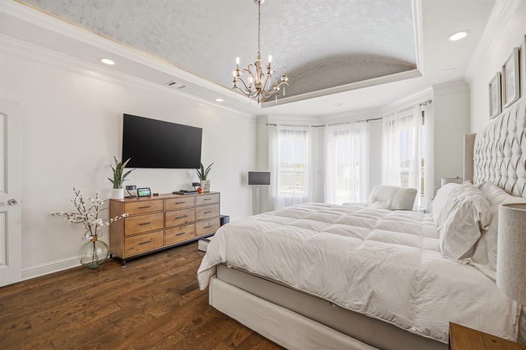 2009 Tree Top Court Granbury, TX 76049 - Photo 23 of 40 a bedroom with a bed and flat screen tv
