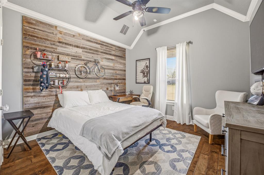 2009 Tree Top Court Granbury, TX 76049 - Photo 27 of 40 a bedroom with a bed and wooden floor
