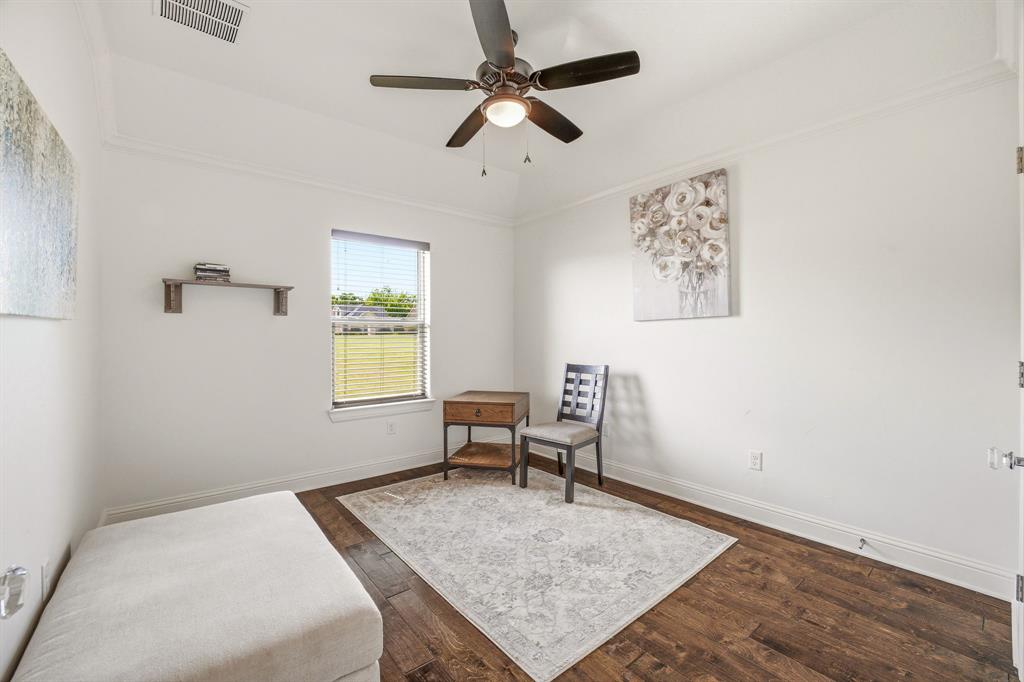 2009 Tree Top Court Granbury, TX 76049 - Photo 29 of 40 a bedroom with a bed and a table