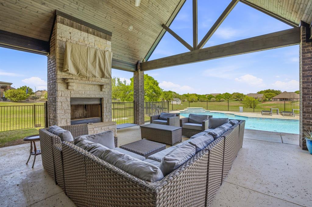 2009 Tree Top Court Granbury, TX 76049 - Photo 32 of 40 a balcony with furniture and a floor to ceiling window