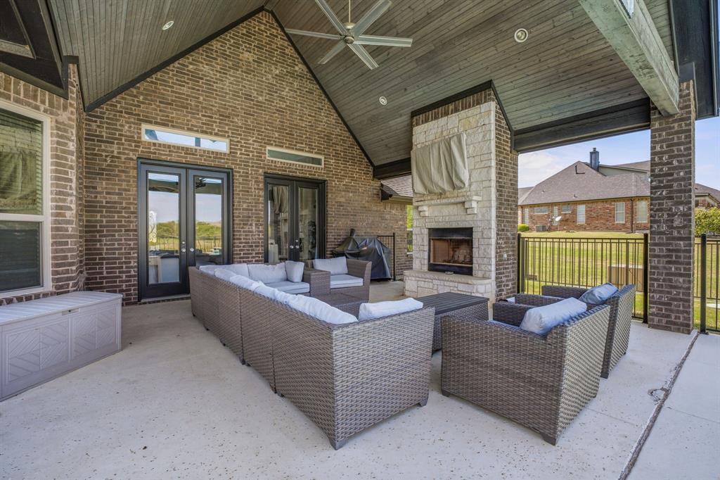 2009 Tree Top Court Granbury, TX 76049 - Photo 33 of 40 a living room with furniture a fireplace and a large window