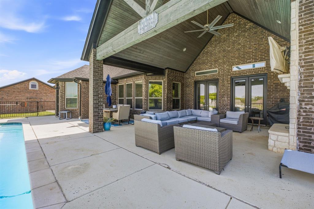 2009 Tree Top Court Granbury, TX 76049 - Photo 34 of 40 a view of the patio with couches and chairs under an umbrella