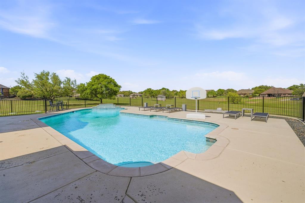 2009 Tree Top Court Granbury, TX 76049 - Photo 36 of 40 a view of a swimming pool and a yard