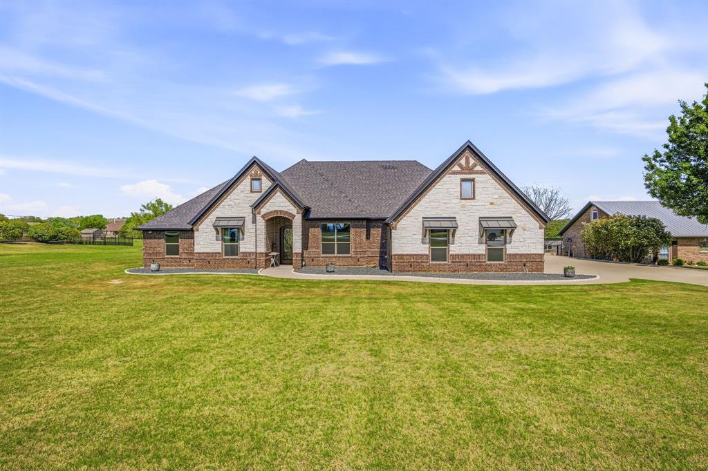 2009 Tree Top Court Granbury, TX 76049 - Photo 5 of 40 a view of house with garden and deck