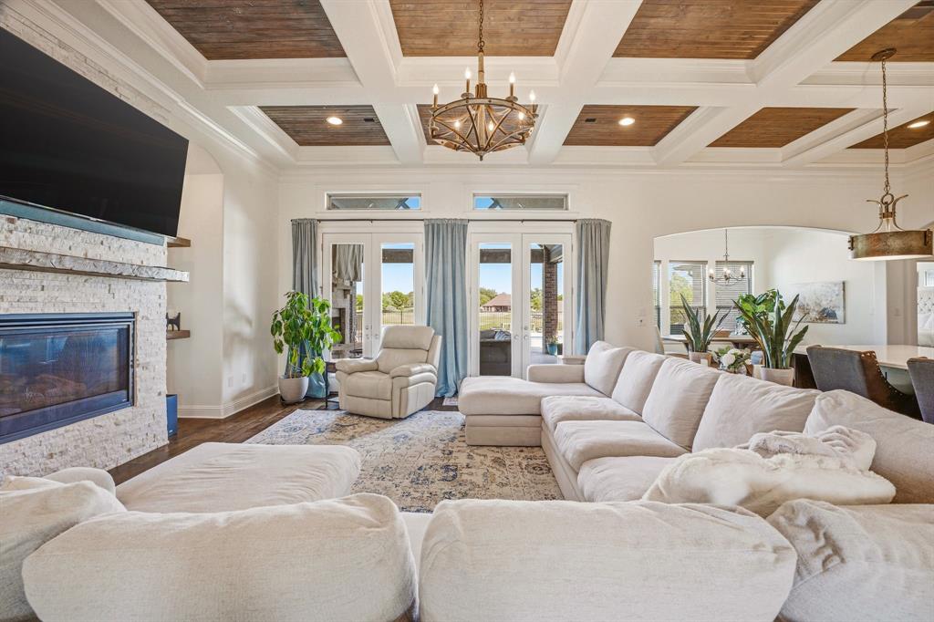 2009 Tree Top Court Granbury, TX 76049 - Photo 9 of 40 a living room with furniture a fireplace and a flat screen tv