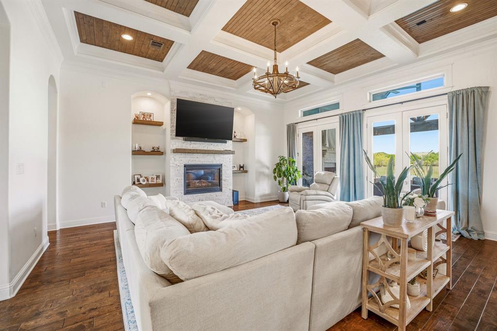 2009 Tree Top Court Granbury, TX 76049 - Photo 10 of 40 a living room with fireplace furniture and a flat screen tv