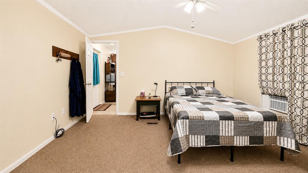 741 Waterfront Row Quitman, TX 75783 - Photo 17 of 40 a bedroom with a bed and a chandelier