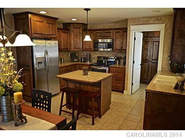 3334 Beaty Road Gastonia, NC 28056 - Photo 4 of 16 a kitchen with stainless steel appliances granite countertop a refrigerator a sink and a stove
