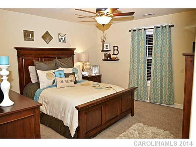 3334 Beaty Road Gastonia, NC 28056 - Photo 8 of 16 a bedroom with a bed and a chandelier