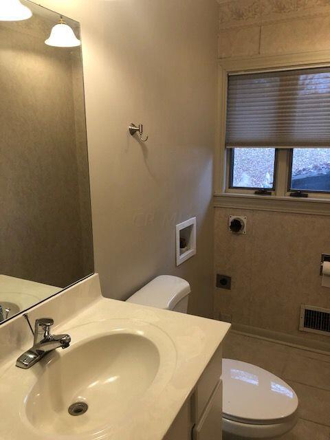 2674 Fishinger Road Upper Arlington, OH 43221 - Photo 18 of 33 Upper level half bath with tile floor, new toilet, and washer/dryer hookup.