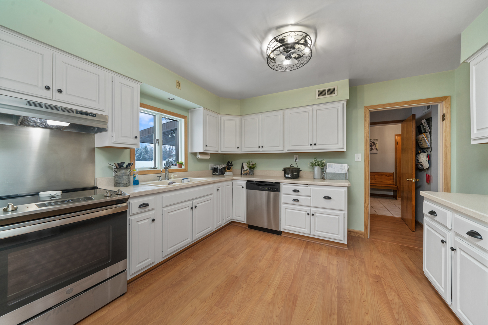 1628 Lee Center Road Amboy, IL 61310 - Photo 11 of 33 a kitchen with cabinets stainless steel appliances and wooden floor