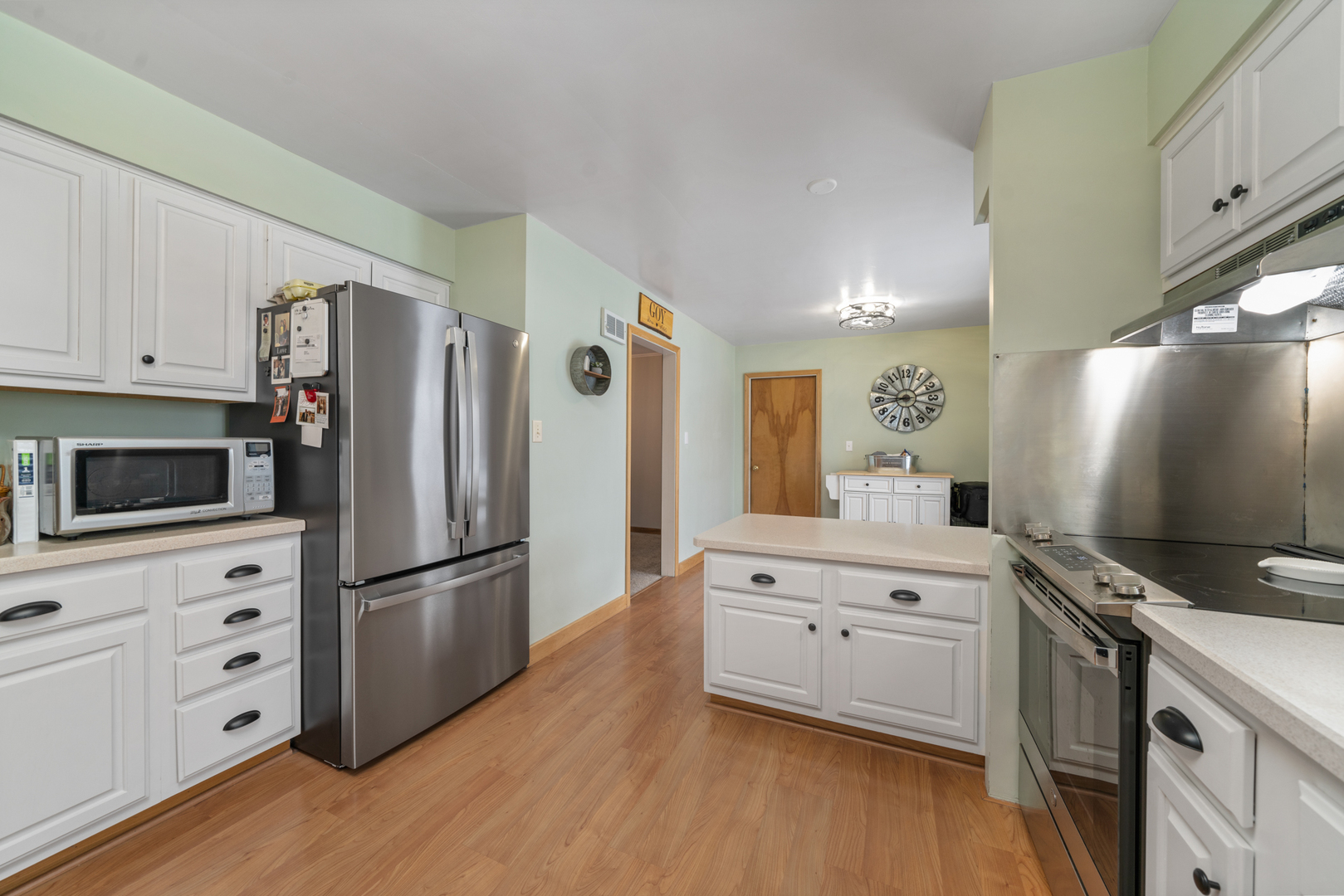 1628 Lee Center Road Amboy, IL 61310 - Photo 13 of 33 a kitchen with granite countertop a refrigerator stove and wooden floor