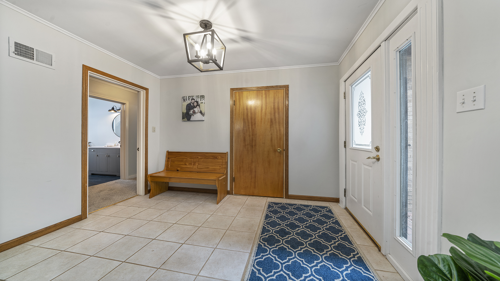 1628 Lee Center Road Amboy, IL 61310 - Photo 2 of 33 a bedroom with a bed and a chandelier