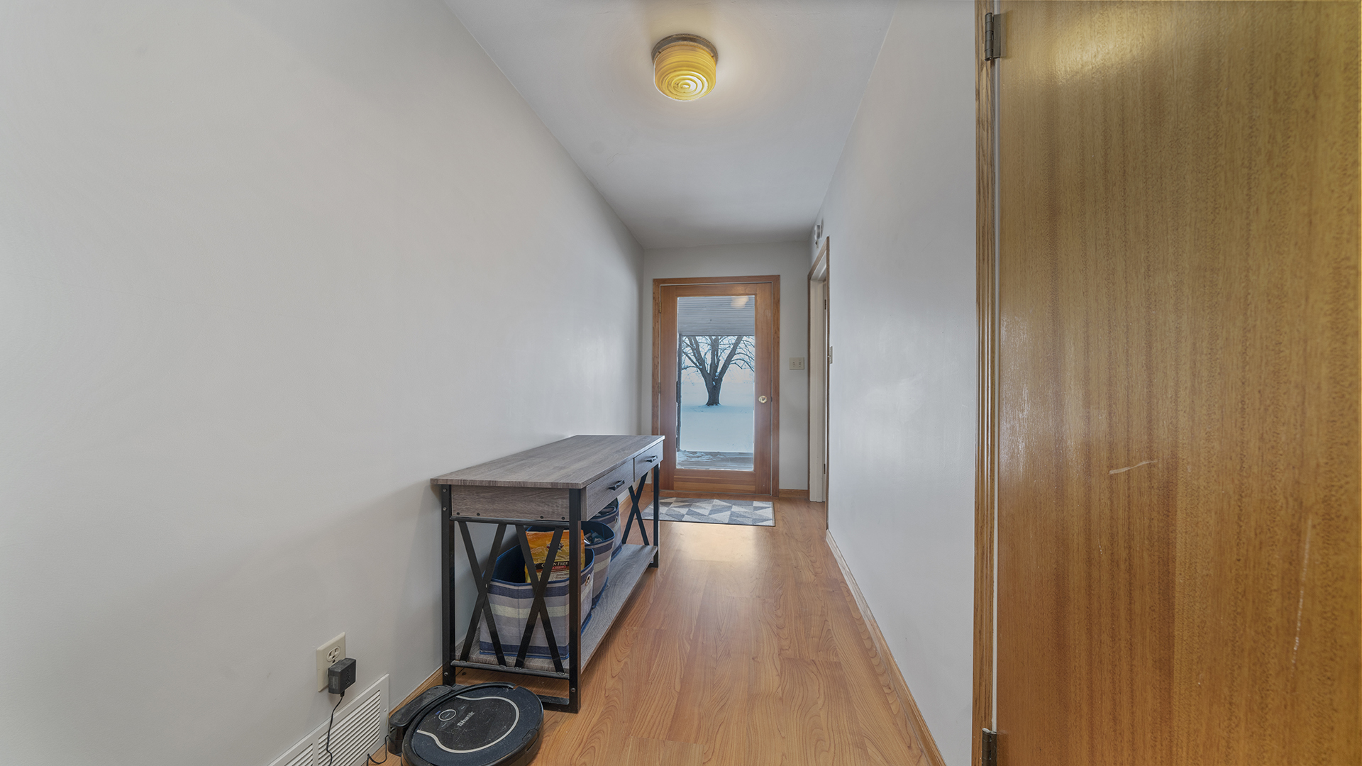 1628 Lee Center Road Amboy, IL 61310 - Photo 9 of 33 a view of a hallway with wooden floor and a potted plant