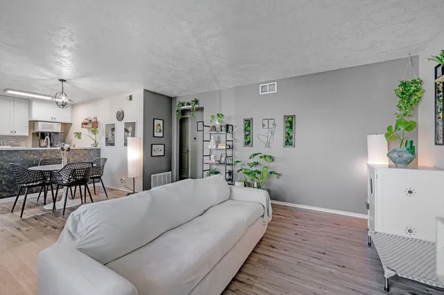 a living room with furniture and wooden floor