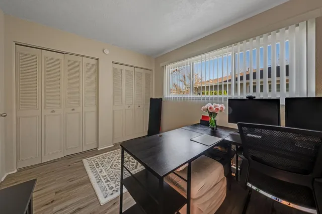 a living room with furniture a flat screen tv and a table