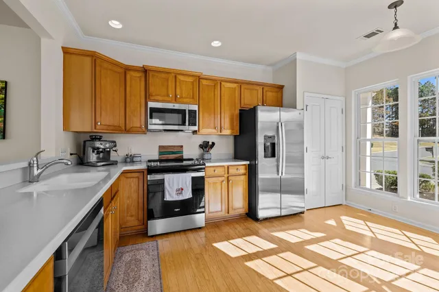 a kitchen with granite countertop a refrigerator and a sink
