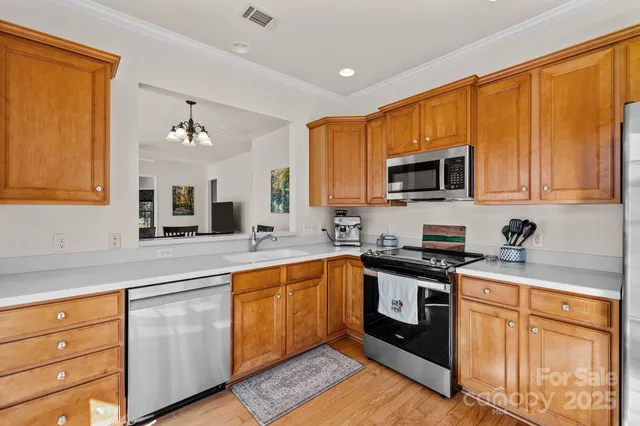a kitchen with stainless steel appliances granite countertop a sink stove and microwave