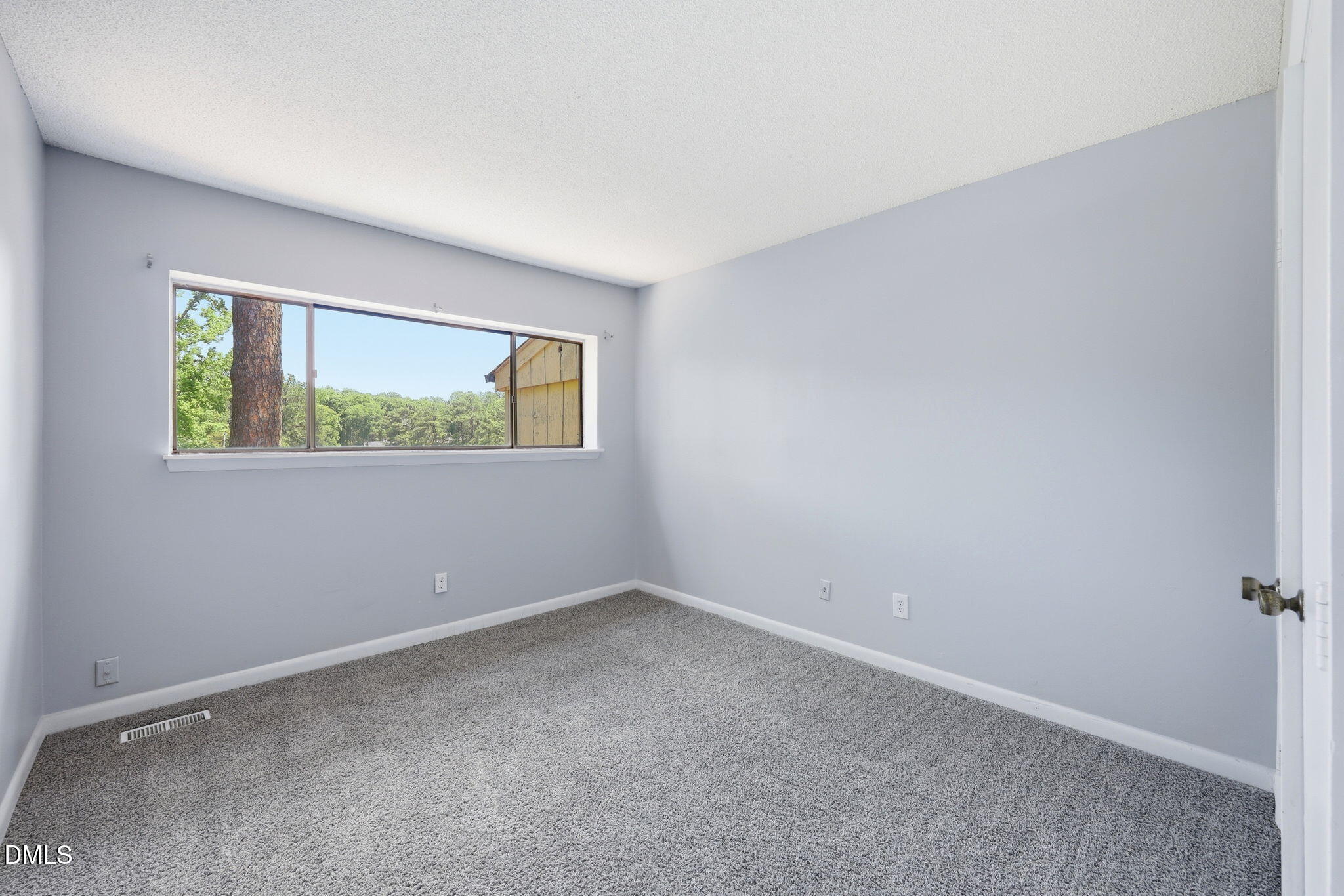 5043 Tall Pines Court Raleigh, NC 27609 - Photo 22 of 37 an empty room with windows