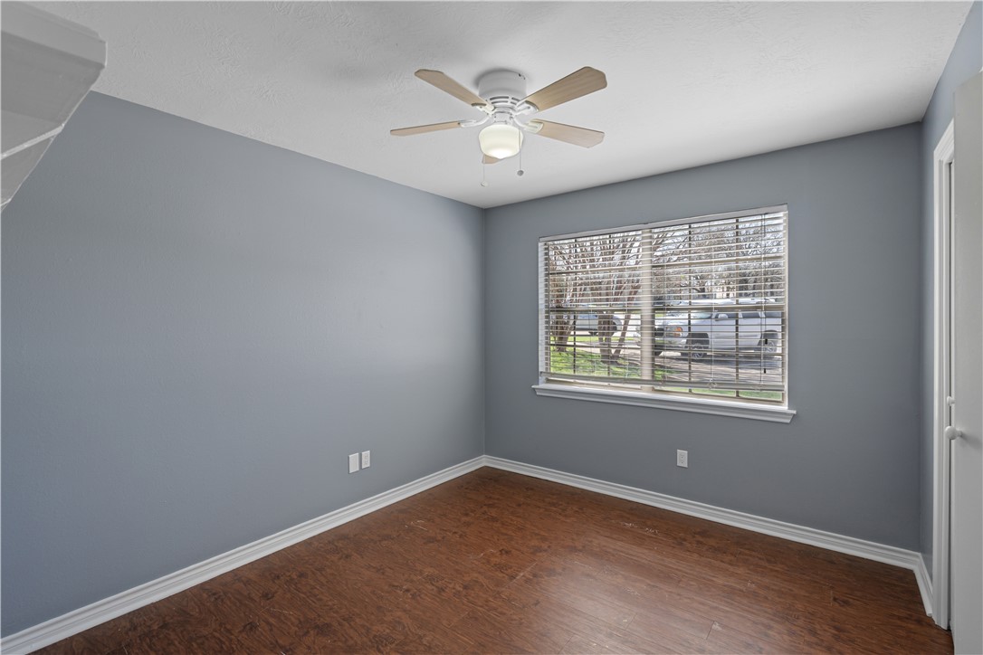 401 Park Road, Unit AB College Station, TX 77840 - Photo 11 of 22 an empty room with a window and a ceiling fan