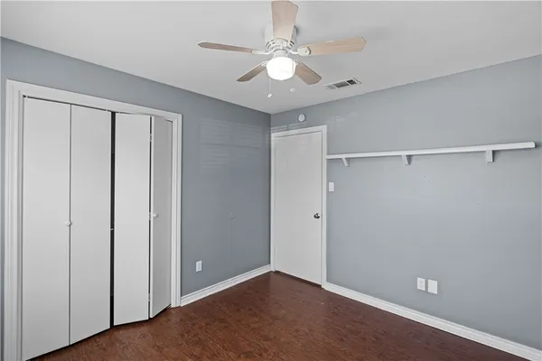 a view of an empty room with a ceiling fan