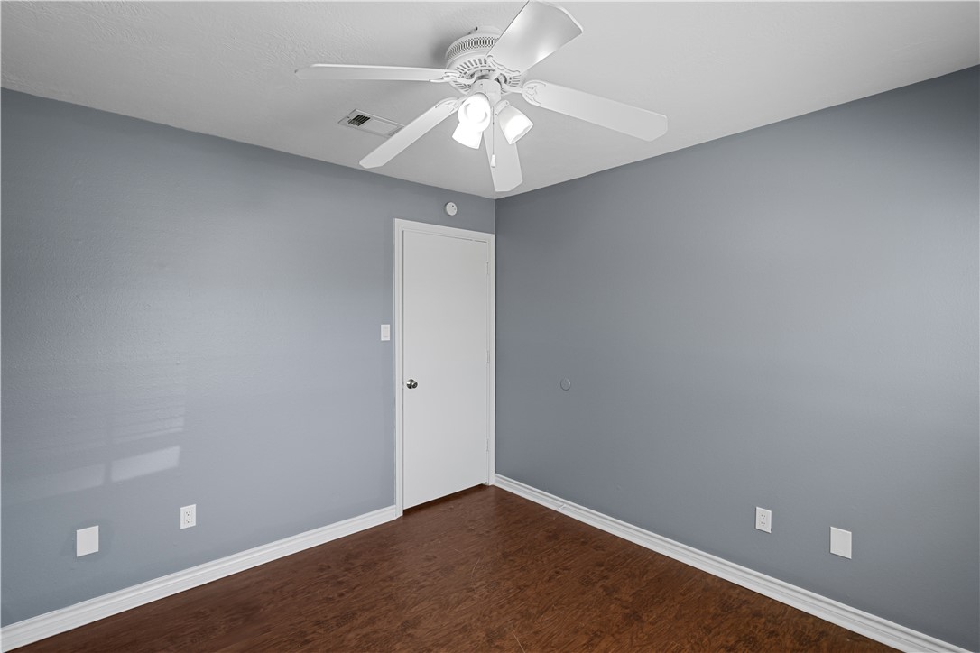 401 Park Road, Unit AB College Station, TX 77840 - Photo 16 of 22 an empty room with a chandelier fan and windows