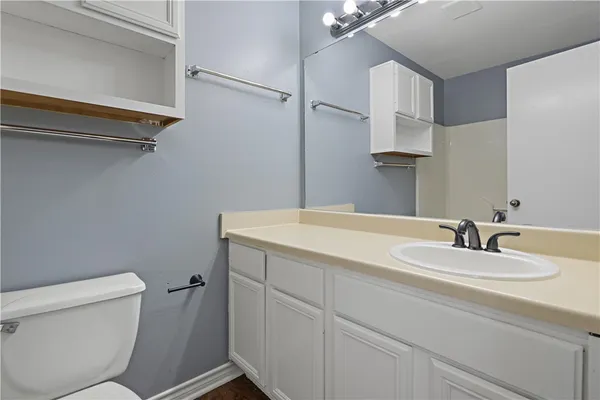 a bathroom with a sink a toilet and vanity