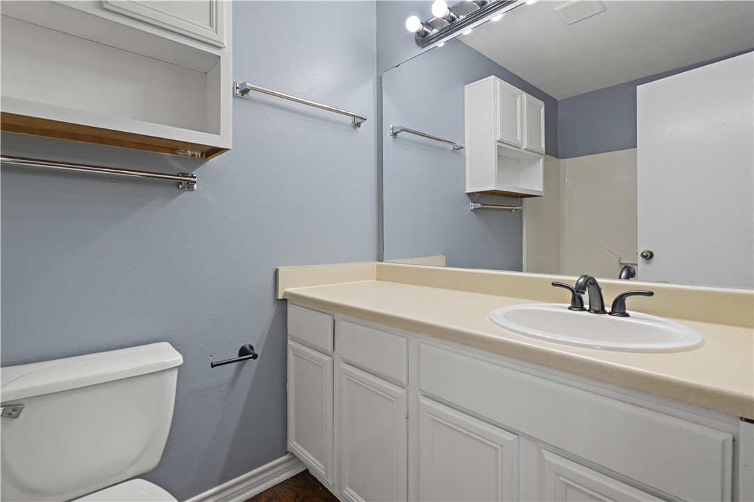 401 Park Road, Unit AB College Station, TX 77840 - Photo 18 of 22 a bathroom with a sink a toilet and vanity